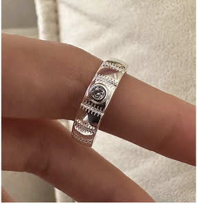 Macro shot of S925 sterling silver ring with textured band and single round zircon
