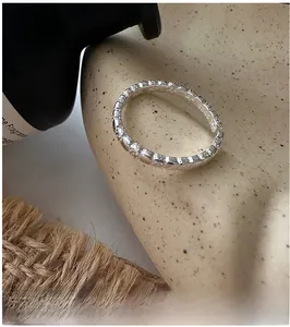 Detailed view of S925 sterling silver ring with square texture and interior hallmark