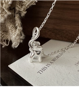Close-up of S925 sterling silver elephant pendant on a delicate link chain necklace