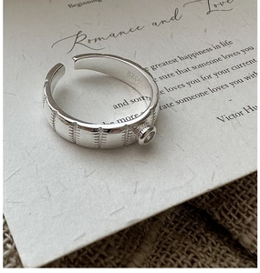 Macro detail of S925 sterling silver ring with vintage texture and single zircon stone