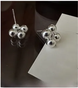 Detailed view of S925 sterling silver ball cluster stud earrings with metal hallmark
