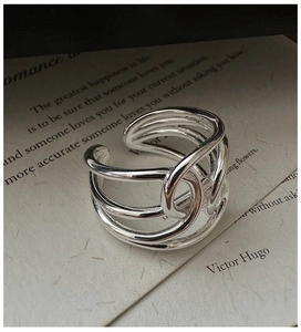 Detail view of a multi-layer silver sterling silver interwoven adjustable open ring