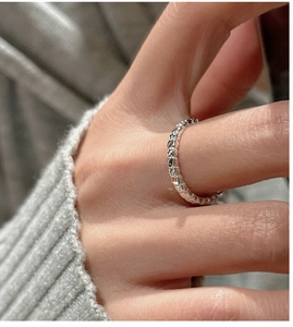 Detail shot of textured S925 sterling silver ring showing its minimalist line patterns
