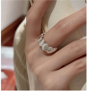 Close-up detail of S925 sterling silver ring with realistic seashell patterns