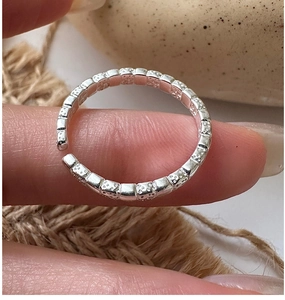 Detailed view of handmade texture and S925 hallmark on minimalist silver open ring