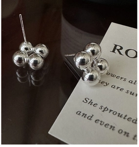 Macro shot of S925 sterling silver ball stud earrings with a polished mirror finish