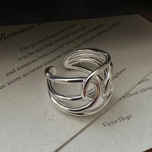 Minimalist S925 sterling silver multilayer intertwined open ring on a vintage book background