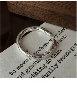 Macro detail of S925 sterling silver ring with rustic hammered texture and C-shape design