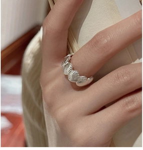 Close-up of S925 sterling silver ring with delicate shell textures and retro finish