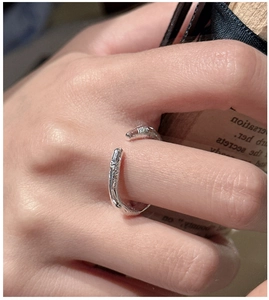 Detail view of the textured S925 sterling silver open ring on a hand with macro photography