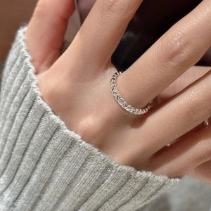 Minimalist S925 sterling silver ring with vintage floral texture on a model finger
