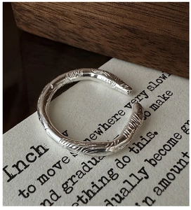 Detail of S925 silver ring featuring handcrafted irregular hammered texture and open design