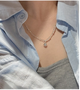 Detail of S925 sterling silver necklace with clear crystal beads on a female model