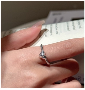 Close-up of S925 sterling silver double heart layered ring worn on a female finger