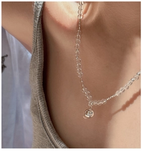 Close-up of S925 silver beaded necklace with clear crystals and hollow ball pendant