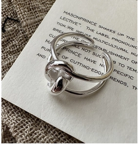 Detailed view of S925 sterling silver ring with minimalist double cross knot design