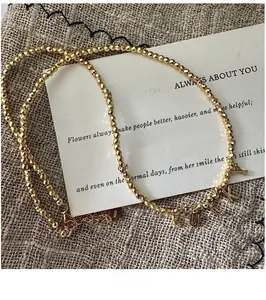Detail of S925 sterling silver beaded necklace with LUCKY letter pendant and gold plating