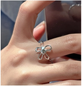 Detailed close-up of a silver flower-shaped ring with artistic liquid metal hollow petals