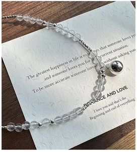 Close-up of S925 sterling silver beaded bracelet with clear crystals and ball pendant