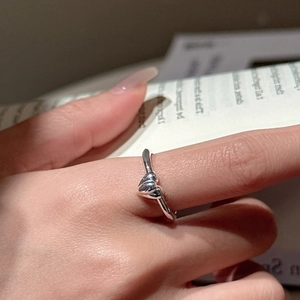 Minimalist S925 sterling silver heart ring featuring interlocked double hearts on a finger