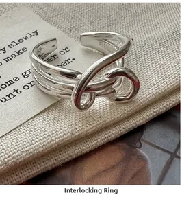 Detailed macro view of S925 sterling silver knotted ring on vintage paper background