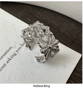 Detail of S925 silver iris ring with hollow floral patterns and marquise cut gemstone