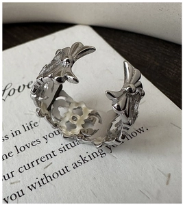 Close-up of S925 sterling silver iris flower ring with retro engraved detailing