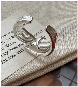 Macro detail of S925 sterling silver knotted ring with a polished intertwined design