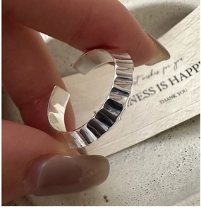 Detail of S925 sterling silver open ring featuring vintage hammered texture and fold design