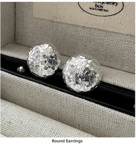 Macro shot of S925 sterling silver hoop earrings with hammered texture in jewelry box