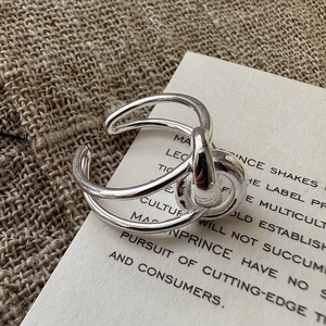 Minimalist S925 sterling silver multi-layer knotted open ring on a vintage aesthetic background
