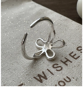 Close-up of S925 sterling silver ring with hollow flower design and mirror finish