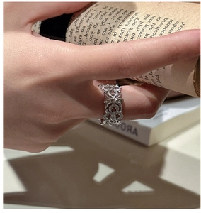 Detail of S925 sterling silver iris ring with intricate hollow engraving and zircons