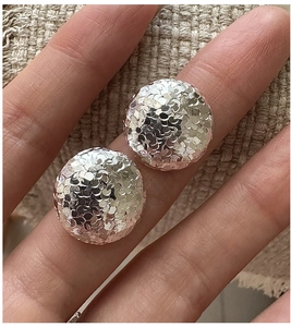 Macro view showing the hammered texture of round S925 sterling silver stud earrings
