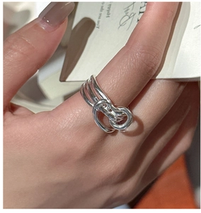 Detail of S925 sterling silver knotted ring with a multi-layered minimalist design