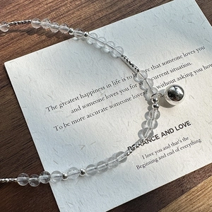 S925 sterling silver necklace with clear beads and polished ball pendant on wood
