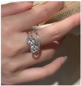 Detail shot of the S925 sterling silver knotted ring on a finger for a vintage chic look