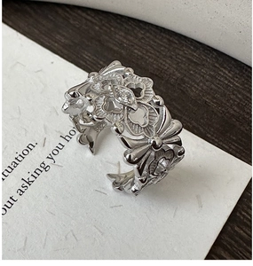 Detailed macro view of S925 sterling silver open ring with intricate hollow floral design