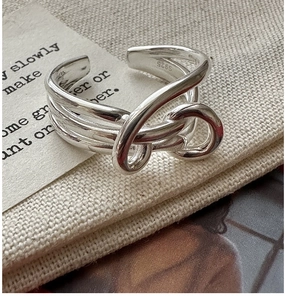 Macro shot of S925 sterling silver stamp on minimalist multi-layer knotted ring band
