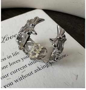 Macro shot of silver iris ring featuring detailed vintage embossed floral engravings