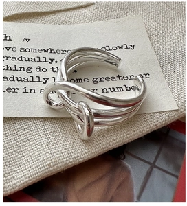 Detailed view of S925 sterling silver multilayer knotted ring on vintage background