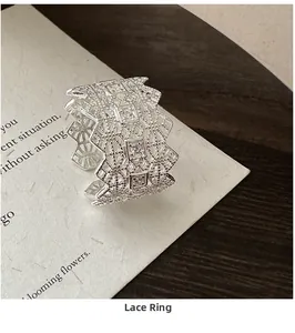 Close-up of S925 sterling silver lace ring featuring hollow texture and zircon inlay
