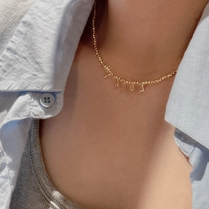 S925 sterling silver beaded necklace with LUCKY letter pendant worn by a model