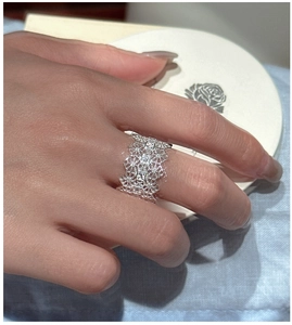Detailed close-up of wide lace hollow silver ring with micro-pave cubic zirconia stones