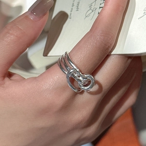 Minimalist S925 sterling silver knotted cross ring worn on finger with elegant card