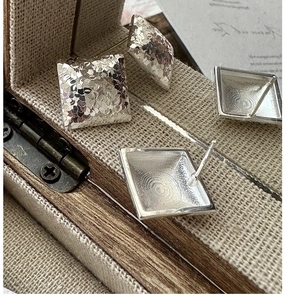 Detail of S925 sterling silver square stud earrings with hammer-textured crushed ice finish