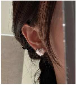 Detailed close-up of a heart-shaped S925 silver earring with a unique hammered metal texture