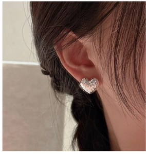 Macro side view of S925 sterling silver heart earring with textured crushed ice finish