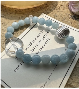 Vue détaillée des perles d'aigue-marine bleu clair et du grand pendentif cœur en argent