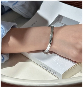 Close-up of a 925 sterling silver cuff bracelet with a textured honeycomb finish